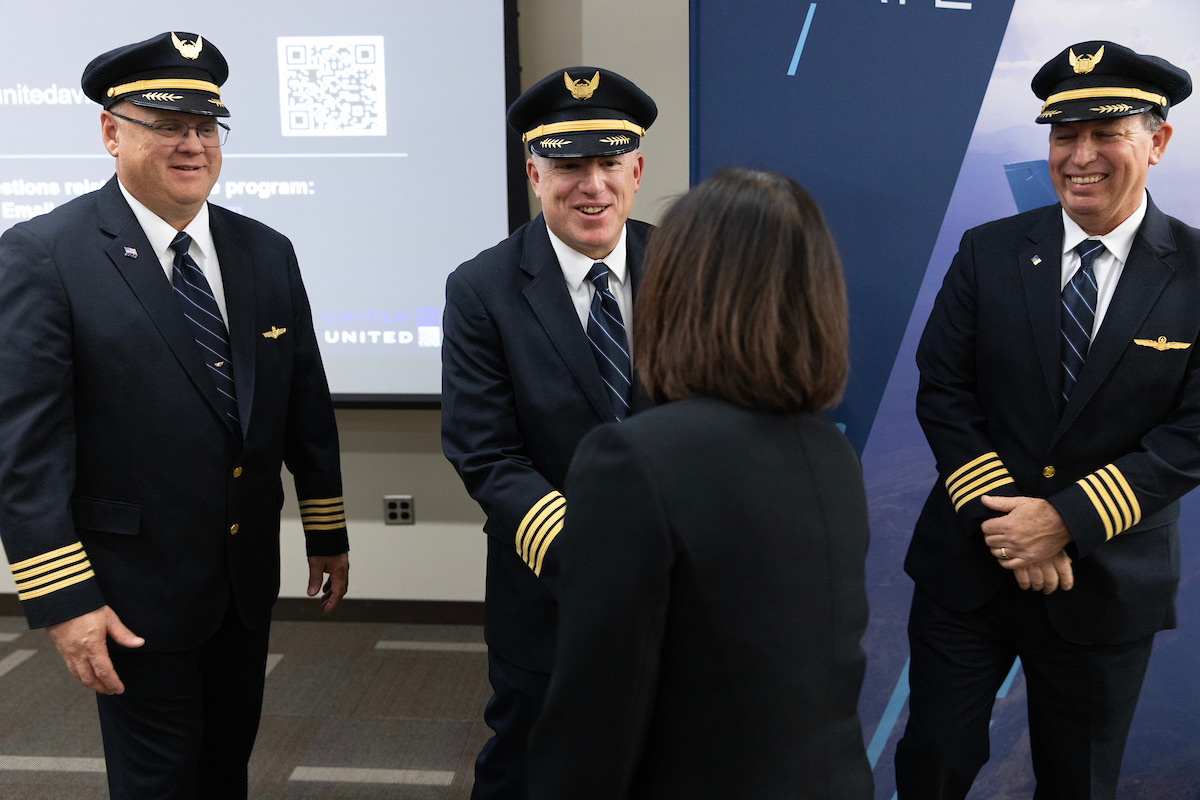 Chancellor Li greeting United Airlines pilots at the ribbon cutting ceremony celebrating UNO's new partnership with United Airlines.