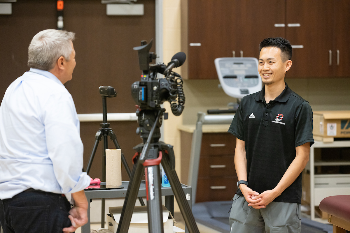 Tomohiro "Tomo" Ide, a doctoral student at UNO, speaks with WOWT reporter Brent Weber about his role at the UNO Pitching Lab prior to an evaluation for a college pitcher.