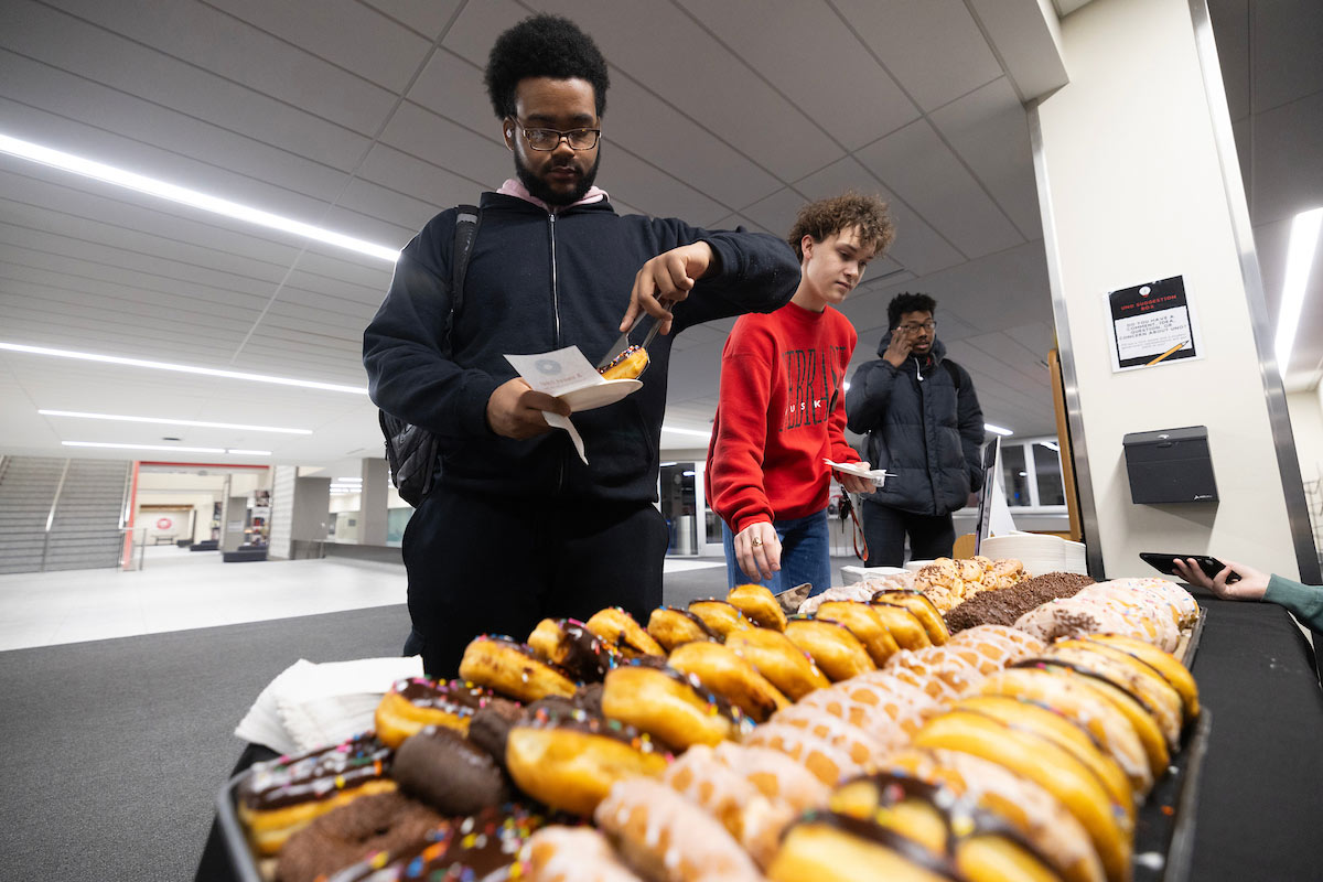 Students picking from a variety of donuts