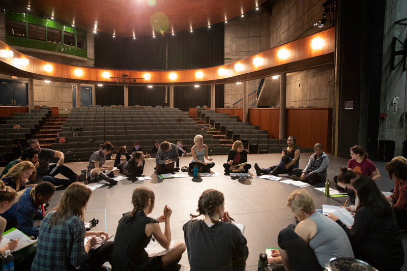 Brown reviews notes with the cast of "All's Well That Ends Well."